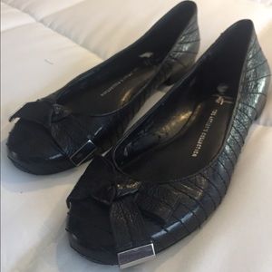 Black leather ballet flats with bow details
